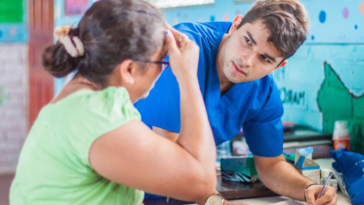 Julian Burgos interviews a woman at a clinic in Nicaragua